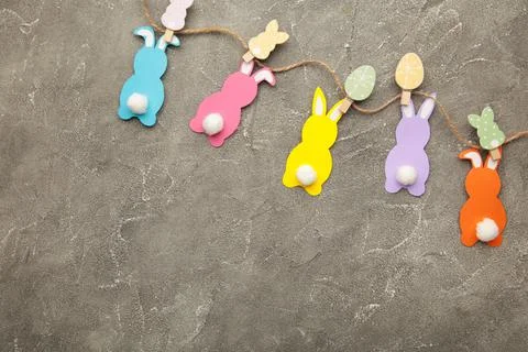 Easter rabbits handmade from colored paper on a rope with clothespins easy cr Stock Photos
