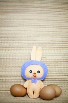 Easter rabbittoy with eggs in the chaff background Fotos de archivo