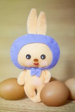 Easter rabbittoy with eggs in the chaff background Fotos de archivo