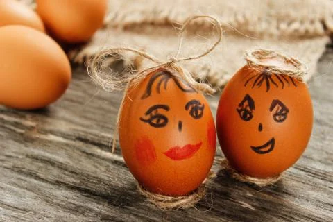 Easter. Raw eggs in the bow on sackcloth on wooden table Stock Photos