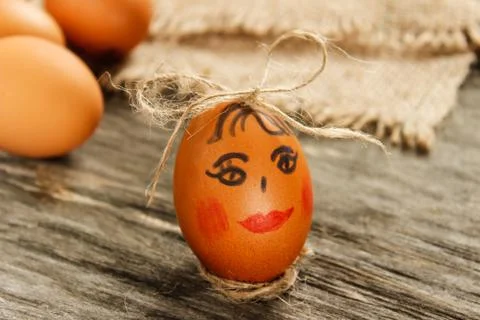 Easter. Raw eggs in the bow on sackcloth on wooden table Stock Photos