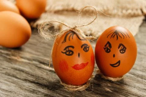 Easter. Raw eggs in the bow on sackcloth on wooden table Stock Photos