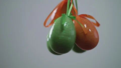Easter red eggs with white folk pattern, hang on red ribbons with bow on white Stock Footage 106634951