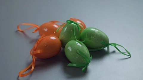 Easter red eggs with white folk pattern, hang on red ribbons with bow on white Stock Footage 106635502