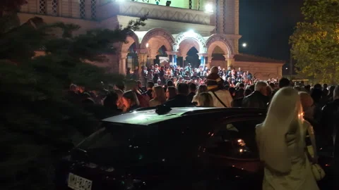 Easter Resurrection Sunday with a crowd outside an Orthodox Church in Greece. Stock Footage 307118822