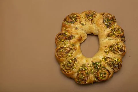 Easter roll with nuts. Brown background with free space for text. Stock Photos