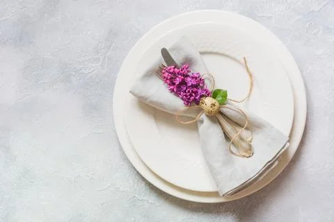 Easter romantic dinner. Elegance table setting with lilac flowers. Stock Photos