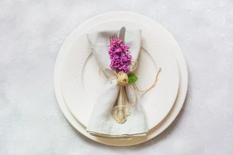 Easter romantic dinner. Elegance table setting with lilac flowers. Stock Photos
