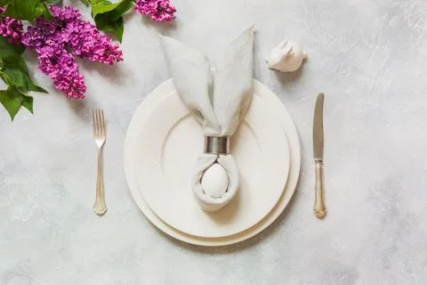 Easter romantic dinner. Elegance table setting with lilac flowers . Stock Photos