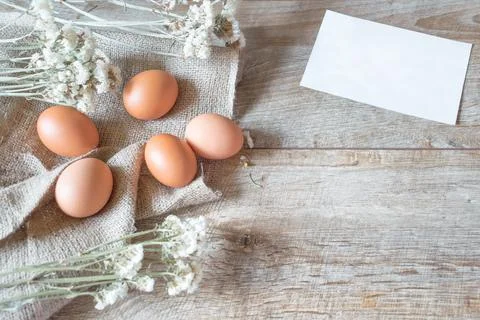 Easter rustic banner copy space text. Brown eggs with napkin and a card flowe Foto stock