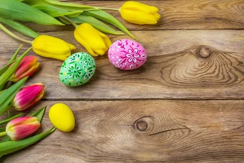 Easter rustic greeting with pink green floral painted eggs Stock Photos