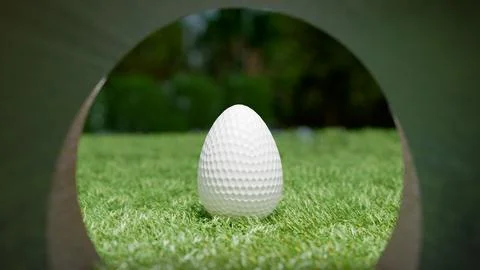 Easter scene a white golf ball shaped like an egg on green grass Illustrazione stock
