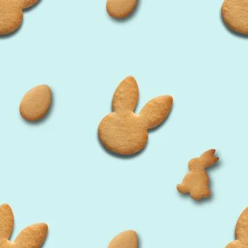 Easter seamless pattern of cookies shaped of bunny and eggs on blue backgroun 스톡 사진