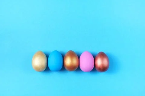 Easter set of colored eggs on bright blue background Easter holiday decoratio Stock Photos