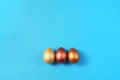 Easter set of gold eggs on bright blue background Easter holiday decorations Stock Photos