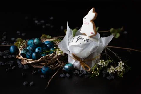 Easter set. Quail eggs and a easter cake with candy in the shape of a rabbit. Stock Photos