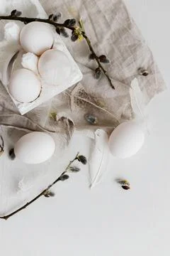 Easter simple aesthetics flat lay. Easter natural eggs, feathers, willow br.. Stock Photos