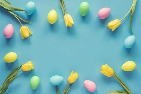 Easter spring background with copy space. Frame of easter eggs and flowers. Stock Photos