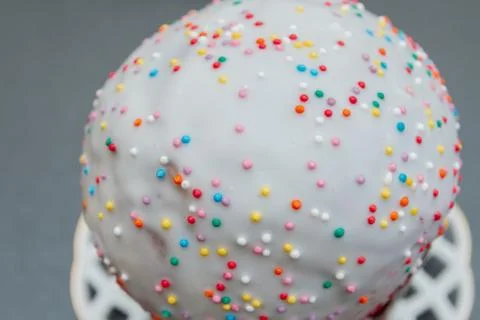 Easter spring cake in white glaze with colored sprinkles Stock Photos
