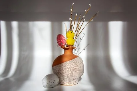 Easter spring decoration with a chick and eggs in a vase with pussy willow Stock Photos