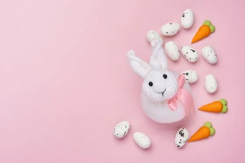 Easter spring greeting card with rabbit bunny, eggs and sweet carrot on pink  Stock Photos