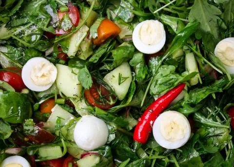 Easter Spring salad with quail eggs, tomatoes and cucumbers Stock Photos