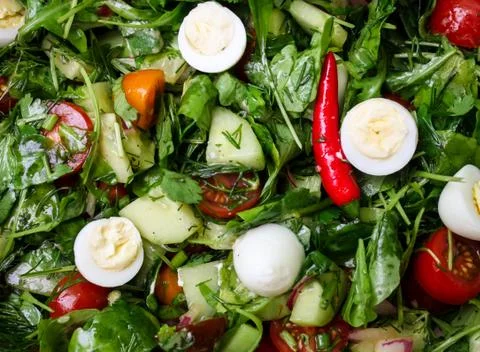 Easter Spring salad with quail eggs, tomatoes and cucumbers Stock Photos