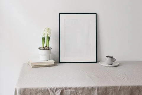 Easter spring still life. Blank black picture frame mockup on linen table cloth Stock-Fotos
