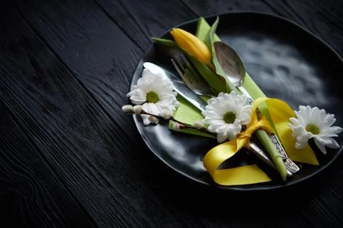 Easter spring table dishware composition with yellow tulip flower Stock Photos
