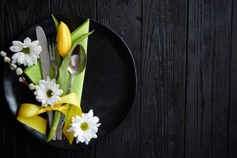 Easter spring table dishware composition with yellow tulip flower Easter s... Stock Photos