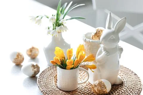 Easter still life with a ceramic hare, eggs and flowers. Stock Photos