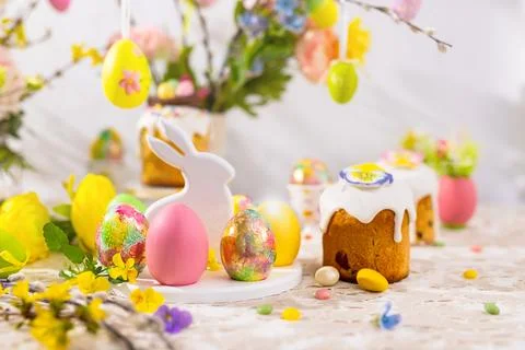 Easter still life with colorful Easter cakes, Easter eggs on rabbit dessert.. Stock Photos