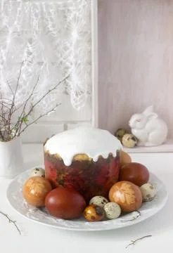 Easter still life with Easter cake kulich and painted eggs on a light backgro Stock Photos