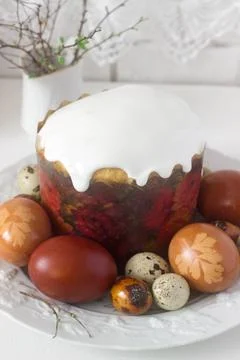 Easter still life with Easter cake kulich and painted eggs on a light backgro Stock Photos