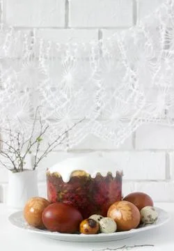 Easter still life with Easter cake kulich and painted eggs on a light backgro Stock Photos