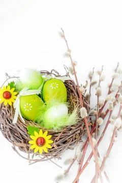 Easter still life. Easter decorated eggs in a nest with a bouquet of willow.. Stock Photos