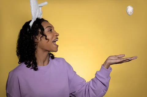 Easter studio shot with cute young woman in easter bunny ears. Stock Photos