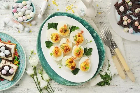 Easter stuffed eggs. Traditional Easter brunch or dinner with stuffed eggs wi Stock Photos