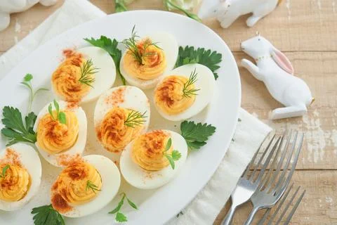 Easter stuffed eggs. Traditional Easter brunch or dinner with stuffed eggs wi Stock Photos