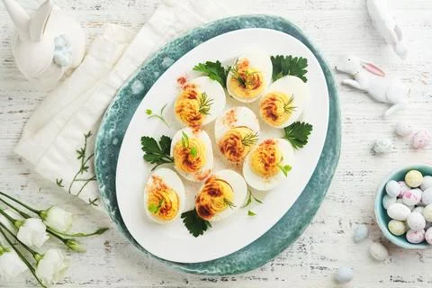 Easter stuffed eggs. Traditional Easter brunch or dinner with stuffed eggs wi Stock Photos