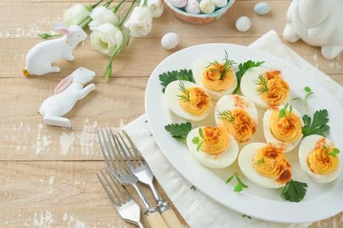 Easter stuffed eggs. Traditional Easter brunch or dinner with stuffed eggs wi Stock Photos