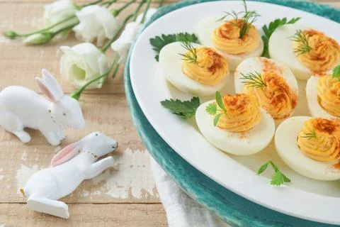 Easter stuffed eggs. Traditional Easter brunch or dinner with stuffed eggs wi Stock Photos