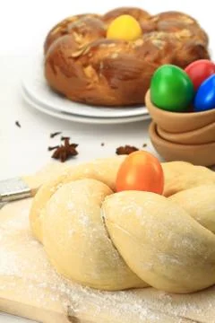 Easter sweet bread dough with multicolored eggs Stock Photos