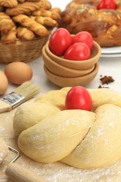 Easter sweet bread dough with red eggs Stock Photos