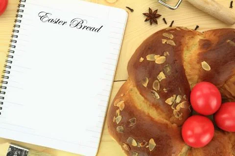 Easter sweet bread with red eggs and recipe book on the table Stock Photos