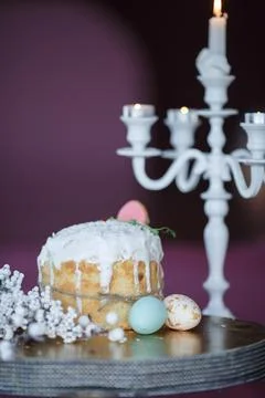 Easter table with colorful eggs and spring flowers on blurred kitchen window Stock Photos