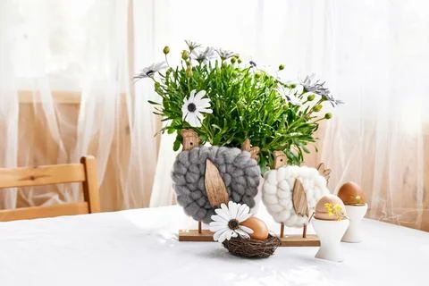 Easter table composition with brown eggs decorated with feathers in white c.. Stock Photos