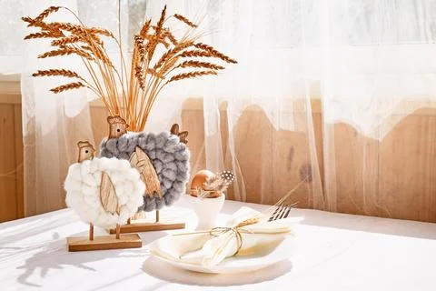 Easter table composition with brown eggs in white ceramic egg cups and wood.. Stock Photos
