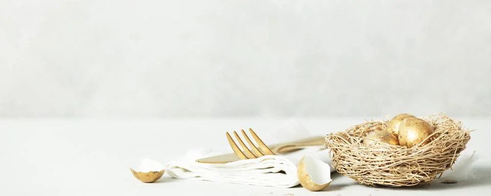 Easter table decorations on light grey background copy space Stock Photos