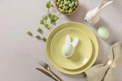 Easter table with green candy almonds and bunny decor Stock Photos